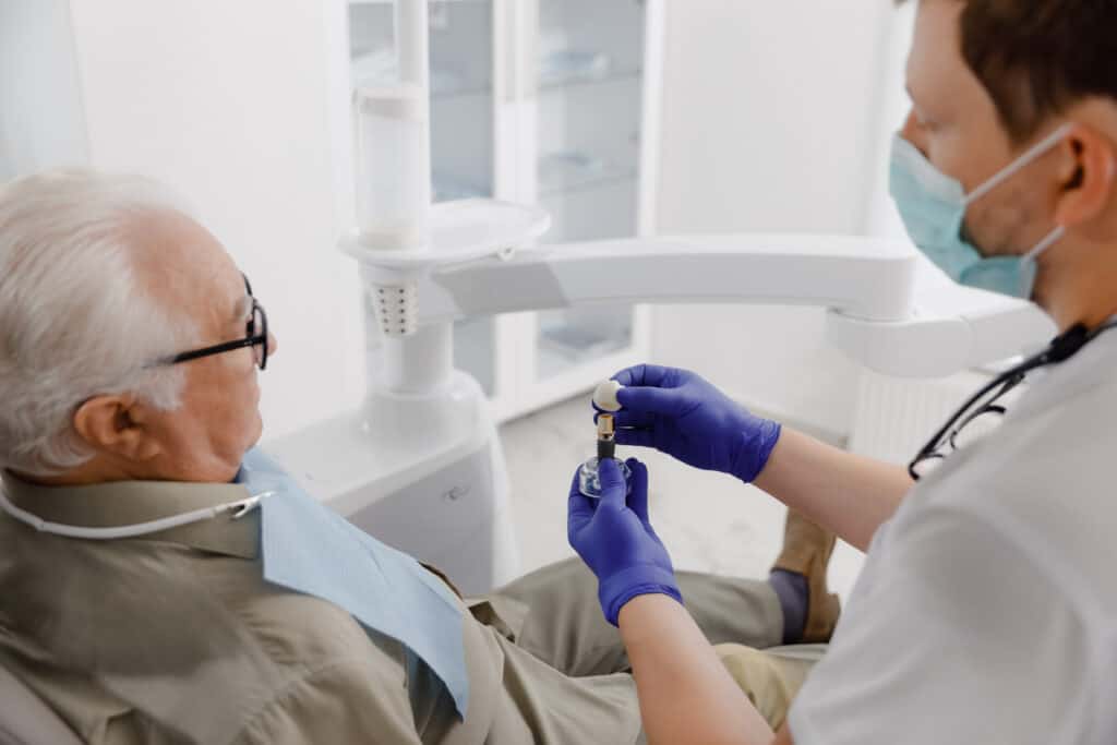 Old man patient have a check appointment at dental clinic the dentist doctor examining the teeth doctor using dental instruments he checking problems with filing